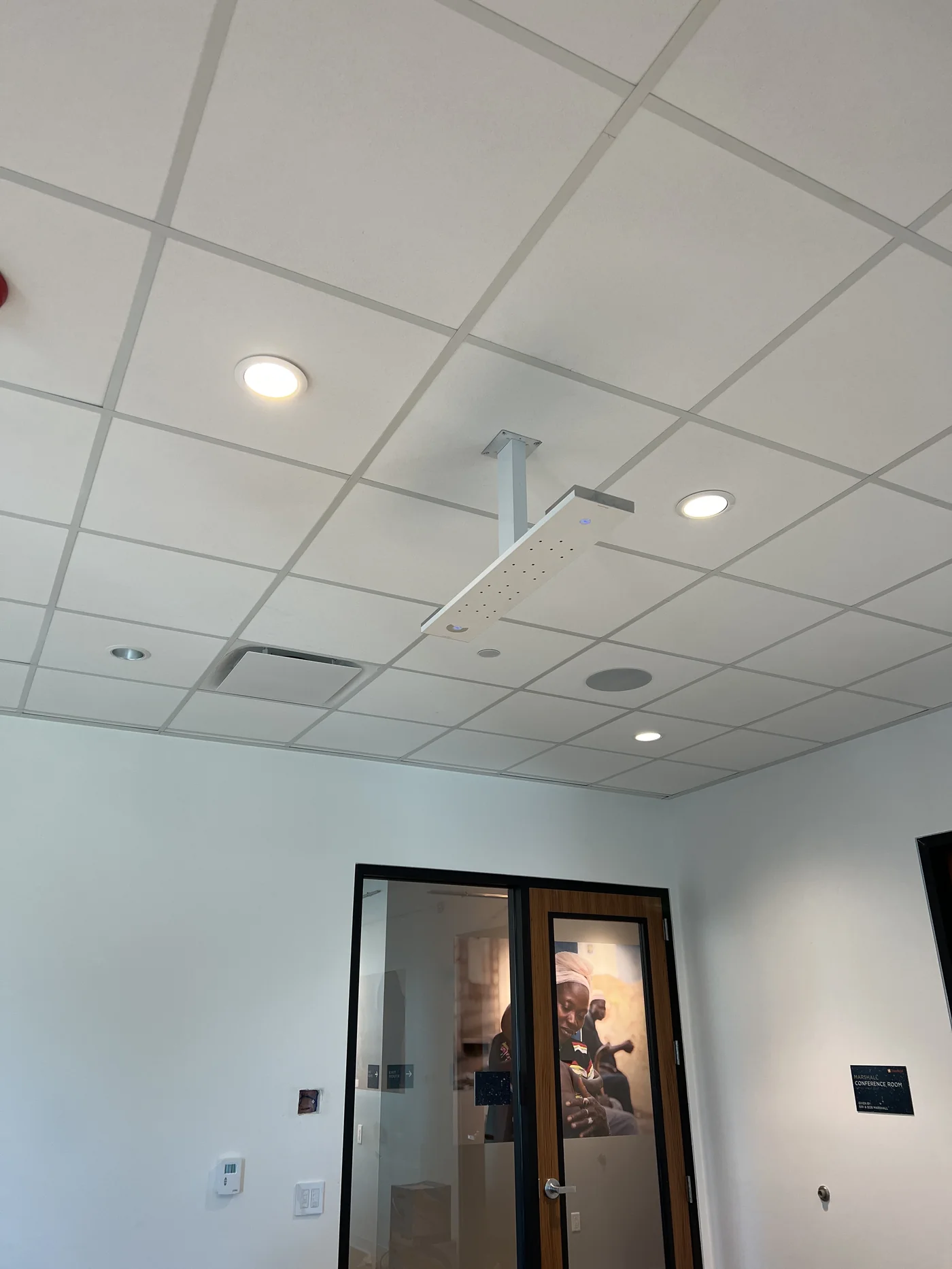 Ceiling-mounted microphone installation in a commercial room
